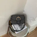 Chic black and white textured small shoulder bag for women, stylish crossbody bag with gold buckle - With Pendant / Black