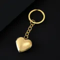 Gold heart locket keychain detail, polished stainless steel keyring, elegant photo holder pendant. - Heart Locket Keychain / Gold