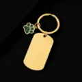 Detailed view of gold stainless steel dog tag keychain featuring a green glitter paw charm. - Military Tag (50X28mm) with Green Glitter Dog Paw / Gold
