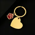 Close-up of gold metal keychain with red glitter paw and blank heart pendant for engraving. - Slanted Heart (30*28.5mm) with Red Glitter Dog Paw / Gold