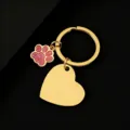 Close-up of the gold metal keychain with pink glitter paw and blank heart pendant. - Slanted Heart (30*28.5mm) with Pink Glitter Dog Paw / Gold