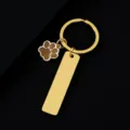 Gold metal keychain featuring a glitter paw charm and a blank rectangular tag for custom engraving. - Rectangle Bar (50X12mm) with Gold Glitter Dog Paw / Gold