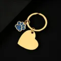 Detailed shot of gold stainless steel keychain with blue glitter dog paw charm and blank heart tag. - Slanted Heart (30*28.5mm) with Blue Glitter Dog Paw / Gold