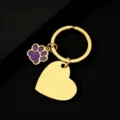 Close-up detail of the metal keychain featuring a purple glitter dog paw charm and blank heart tag. - Slanted Heart (30*28.5mm) with Purple Glitter Dog Paw / Gold