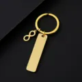 Vista detallada de llavero de acero inoxidable dorado con símbolo de infinito y etiqueta. - Barra y Símbolo de Infinito y Anillo de Llavero / Conjunto Dorado