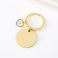 Stainless steel mustard seed keychain detail showing the clear heart charm and gold blank disc. - 30mm Circle And Heart Charm Key Ring / Gold