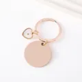 Detail view of rose gold mustard seed keychain with blank round tag and heart pendant. - 30mm Circle And Heart Charm Key Ring / Rose Gold