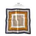 Detail shot of the geometric square silk scarf, showcasing elegant blue and gold pattern. - P703