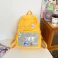 Yellow transparent itabag backpack with clear front pocket and cute anime badges for students. - Yellow