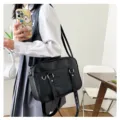 Detail view of the black PU leather JK uniform shoulder bag, showing wearing effect and texture. - Black
