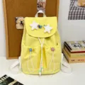 Japanese style cute yellow backpack for students with plush star pendants and front pockets. - Star Safety Pin Style / Yellow