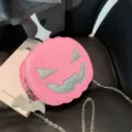 Trendy pink Halloween pumpkin crossbody bag with chain strap and cute cartoon face design. - One Size / Pink
