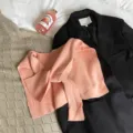 Detailed view of women knitted solid color shrug shawl flat lay scene styling outfit. - Pink