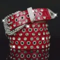 Red rhinestone studded women belt with metal eyelets and shiny pin buckle for jeans main view. - Burgundy