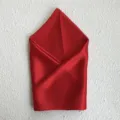 Detailed view of a luxurious red silk square scarf, perfectly folded for elegant gift presentation. - Red