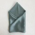 Detail shot of a elegant grey-green mulberry silk square scarf, soft and smooth texture. - Autumn Smoke