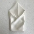 Detailed view of an elegant ivory silk square scarf, soft texture and refined natural sheen. - Off White