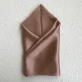 Close-up detail of smooth brown silk square scarf showcasing fine fabric texture and soft drape. - Dusty Pink