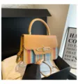 Detailed view of the stylish color-block shoulder bag with top handle and woven design for women. - Khaki