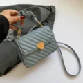 Light blue quilted shoulder bag with gold heart clasp and gathered handle for women - Blue