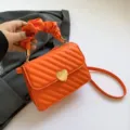 Orange trendy shoulder bag with heart lock and gathered handle, fashionable variant. - Orange