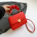 Red quilted crossbody bag with heart clasp and ruched handle for women stylish daily use - Red