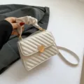 Trendy white quilted shoulder bag for women with cute heart clasp and stylish handle design. - White