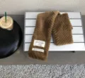 Winter warm brown plush faux fur scarf with decorative white cloth labels, soft and cozy style. - Dark Khaki