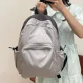 Casual grey backpack for women, stylish student schoolbag with front pocket and side slots. - Bag Only / Silver Gray