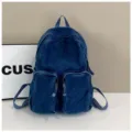 Blue denim backpack detail, casual daily student school bag with dual front pockets. - One Size / Dark Blue