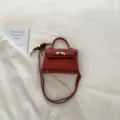 Red stylish top handle shoulder bag with classic lock closure for women daily wear and chic look. - Red