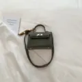 Dark green mini Kelly handbag, chic top handle crossbody bag with lock closure and charm. - With Pendant / Green