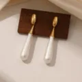 Vintage gouden lange druppel parel oorbellen elegante metalen witte hangende oorknoppen - Honkbalvorm (E2257)