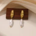 Close-up of vintage style drop earrings featuring irregular gold metal top and baroque pearl. - Baroque Pearl (E2262)