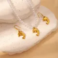 Gold dolphin pendant necklace and matching earrings detailed shot, summer ocean style jewelry. - Artificial Pearl Dolphin Set (BJGS0119)