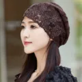 Detailed close-up of brown lace slouchy cap with shimmering rhinestones worn by model. - Adult Style / Coffee