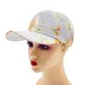 Detail view highlighting the grey floral print fabric texture and curved brim of the cap. - Adult / Floral Color 6