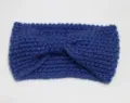 Detailed view of blue knit twist headband, cozy winter hair accessory for warm styling. - Denim Blue