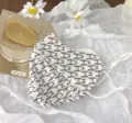 Summer UV protection face mask with black and white geometric pattern detail. - Swallowtail