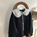 Detailed view of dark blue sweater with delicate white lace embroidered detachable doll collar. - 3 Layers