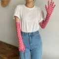 Detailansicht roter gemusterter Sonnenschutz-Ärmel, kombiniert mit weißem T-Shirt und Jeans. - Rot Beige Geometrischer Stil