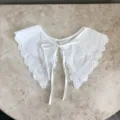 Nahaufnahme Detail eines weißen spitzenbestickten abnehmbaren falschen Kragens mit Schleife. - Stil V (Mittlere Größe)