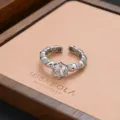 Silver open ring featuring a sparkling cubic zirconia stone and detailed textured band. - Vintage Solitaire Light Luxury Style (JZ0228)