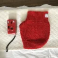 Red knitted balaclava hat for women, cozy winter warm earflap beanie cap detail view. - 24x31cm / Red