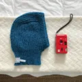 Blue knitted balaclava detail view, winter warm hooded hat, cozy woolen earflap hat close up - 24x31cm / Dark Blue
