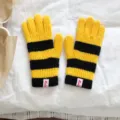 Close-up detail of yellow and black striped knitted winter warm gloves with cuff label. - 12x23cm-F004 / Yellow