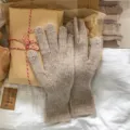 Detailed shot of winter warm knitted touch screen gloves in oatmeal color, cozy style. - One Size / Khaki