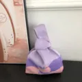 Stylish purple and pink knitted handbag featuring a unique knot handle design for women. - Violet
