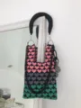 Detailed view of the colorful knit shoulder bag with heart pattern and chunky chain handle. - Black Handle Chain Bag Style / Pink Gray Green