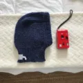 Navy blue knitted balaclava detail view, showing soft woolen texture, ear protection design. - 24x31cm / Navy Blue